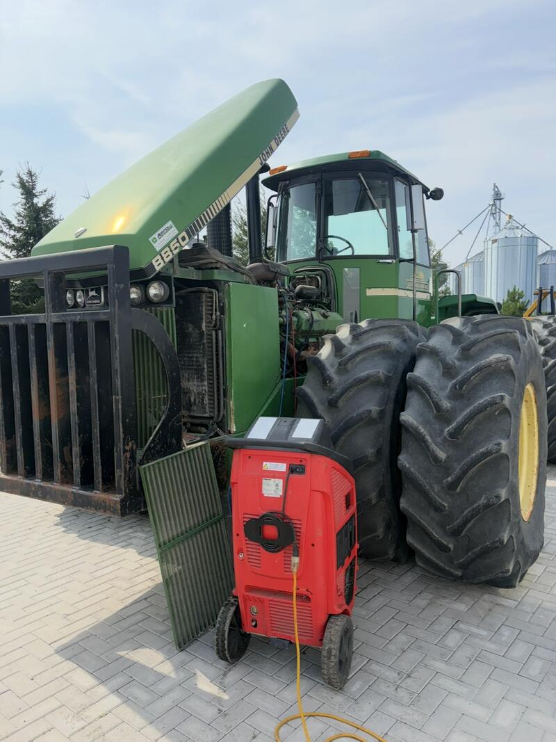 John Deere four-wheel-drive tractor with an A/C service unit
