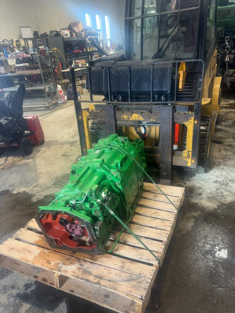 Green tractor transmission on a pallet in the shop